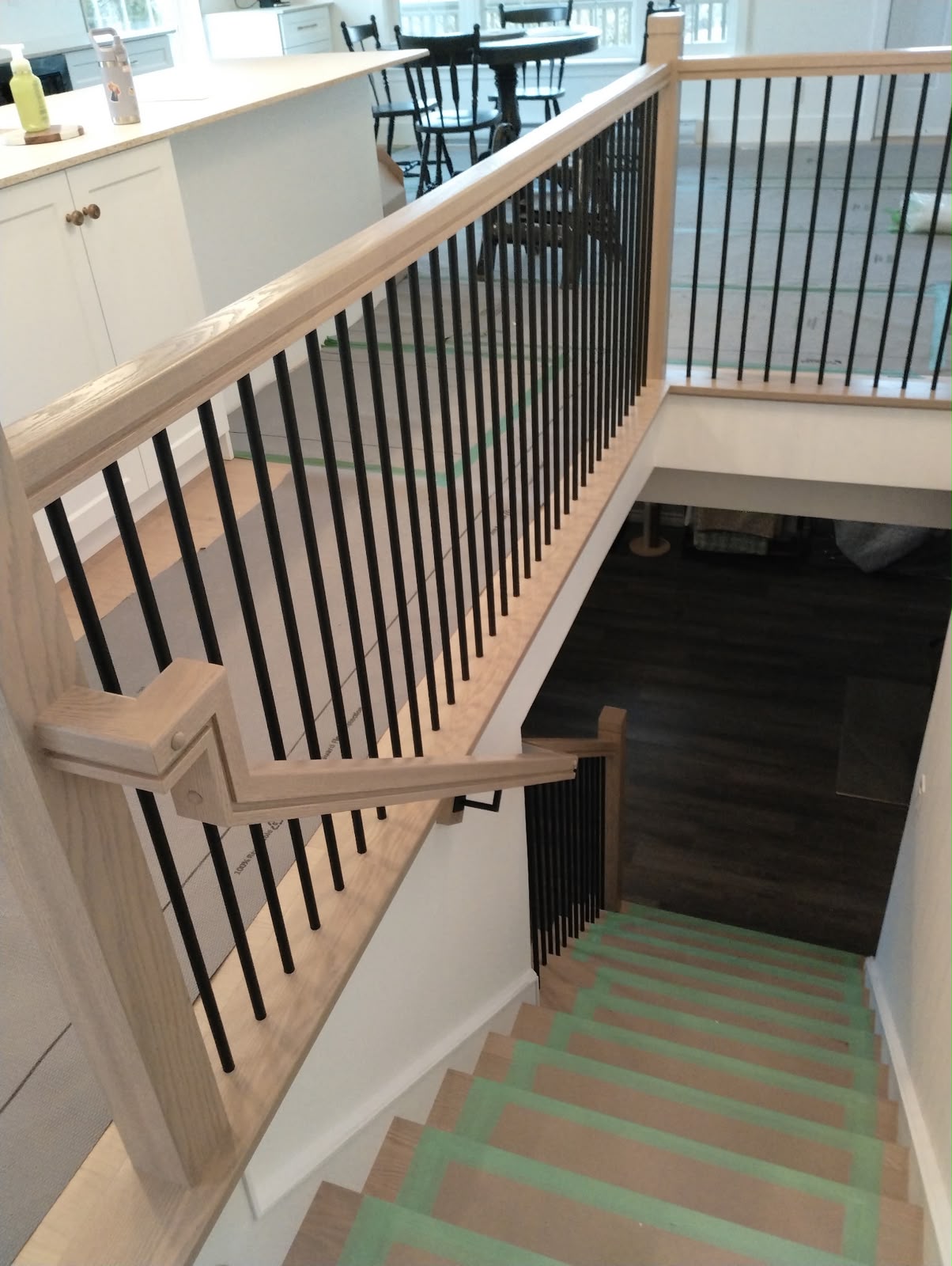 Hardwood staircase railing with black balusters